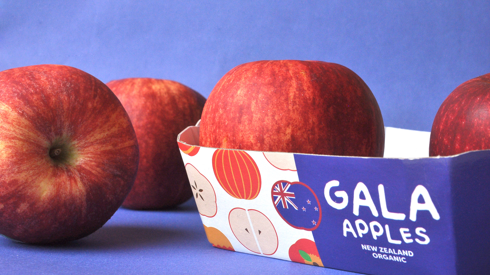 GALA 新西蘭有機蘋果節慶敞開式包裝盒設計，新西蘭國旗色+扁平圖標組合